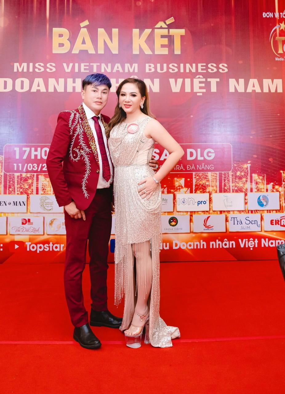 A person and person posing for a picture on a red carpetDescription automatically generated